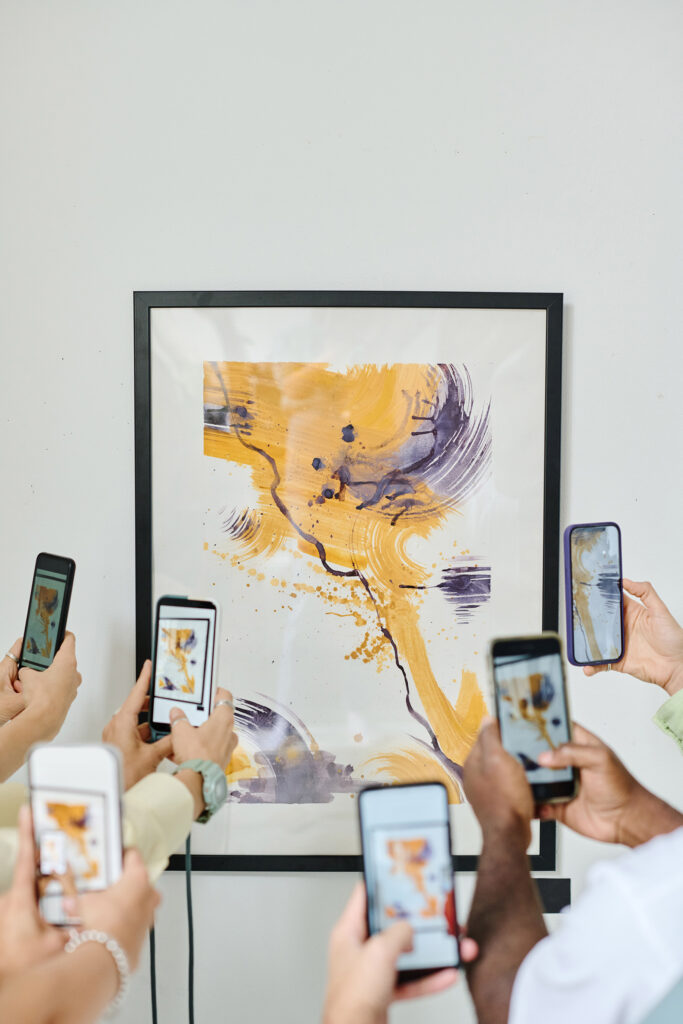 People photographing modern art at gallery